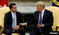 FILE - U.S. President Donald Trump meets with Puerto Rico Governor Ricardo Rossello in the Oval Office of the White House in Washington, Oct. 19, 2017.