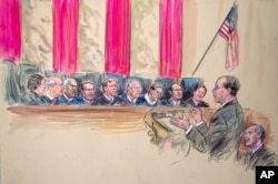 This artist rendering shows Paul Clement, second from left, with Solicitor General Donald B. Verrilli Jr. seated, right, addresses the Supreme Court in Washington, Wednesday, March 27, 2013, as the court heard arguments on the Defense of Marriage Act.