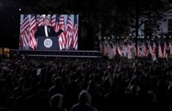 U.S. President Donald Trump is seen on a screen as he delivers his acceptance speech as the 2020 Republican presidential nominee during the final event of the Republican National Convention on the South Lawn of the White House in Washington.