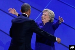 Democratic presidential nominee Hillary Clinton hugs President Barack Obama after she joins him on stage during the third day of the Democratic National Convention in Philadelphia , Wednesday, July 27, 2016. (AP Photo/J. Scott Applewhite)