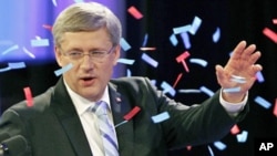 Conservative Party leader and Canadian Prime Minister Stephen Harper waves to supporters at his federal election night headquarters in Calgary, Alberta, May 2, 2011.