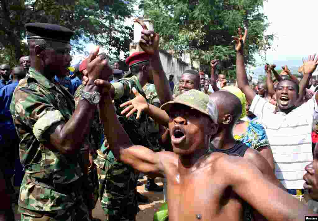 People greet soldiers as they celebrate in Bujumbura, Burundi, May 13, 2015.