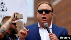 FILE - Alt-right conspiracy theorist Alex Jones speaks during a rally near the Republican National Convention in Cleveland, Ohio, July 18, 2016.