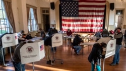 Voters cast their ballots at the old Stone School, used as a polling station, on election day in Hillsboro, Virginia on November 3, 2020.