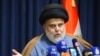 FILE - Populist Shiite cleric Moqtada al-Sadr speaks during a press conference in Najaf, Iraq, Nov. 18, 2021. 