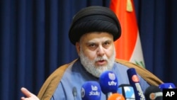 FILE - Populist Shiite cleric Moqtada al-Sadr speaks during a press conference in Najaf, Iraq, Nov. 18, 2021. 
