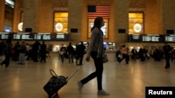 A woman pulls her luggage at Grand Central Station while Hurricane Sandy approaches New York, October 28, 2012. 