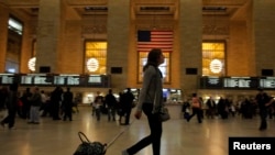 A woman pulls her luggage at Grand Central Station while Hurricane Sandy approaches New York, October 28, 2012.