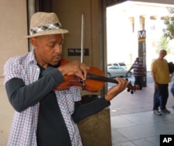 Street musician Raycurt Johnson plays patriotic music near a subway stop in downtown Washington