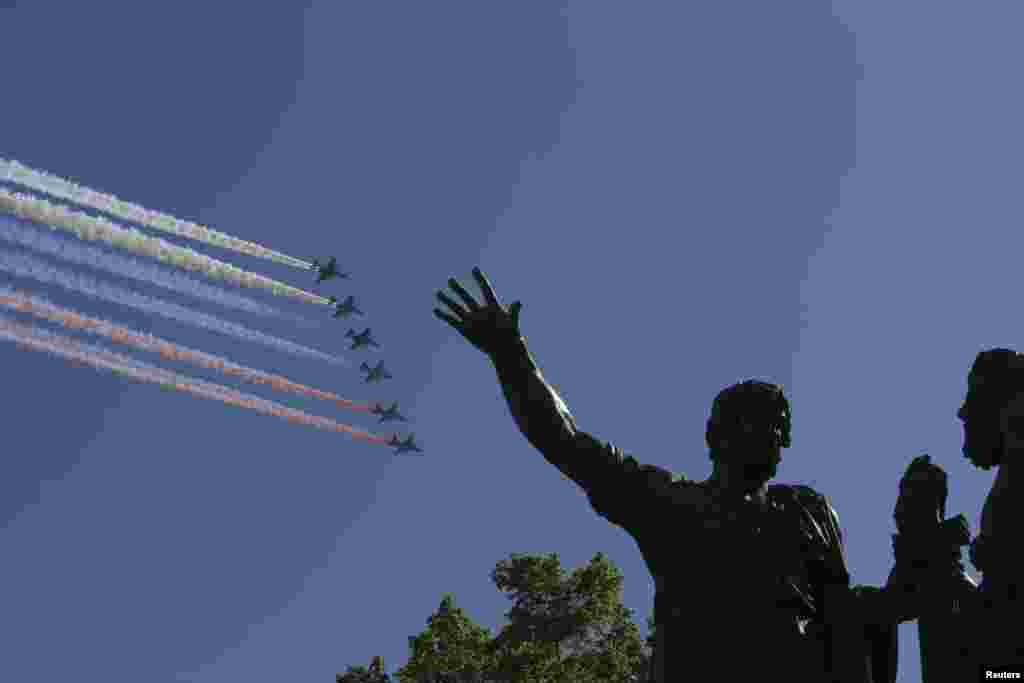 Russian military aircraft trail smoke in the colors of the Russian tricolor above the Monument to Minin and Pozharsky during the Victory Day Parade in Moscow&#39;s Red Square.