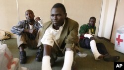 Opposition party Movement for Democratic Change (MDC) supporters from the rural south of the country show their broken limbs from an assault in the capital Harare, May 3, 2008.
