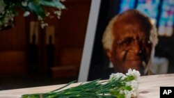 A bunch of carnations sits atop the pine coffin at the funeral of Anglican Archbishop Emeritus Desmond Tutu at the St George's Cathedral in Cape Town South Africa, Saturday, Jan 1, 2022. 