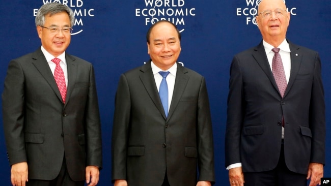 Thủ tướng Nguyễn Xuân Phúc chụp ảnh với Phó Thủ tướng Trung Quốc Hồ Xuân Hoa và Chủ tịch Diễn đàn Kinh tế Thế giới, ông Klaus Schwab, hôm 12/8.