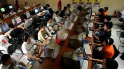 Chinese youths use computers at an Internet cafe in Beijing