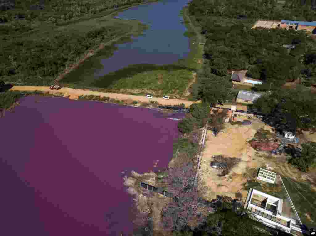 A road divides the Cerro Lagoon and the Waltrading S.A. tannery, bottom right, in Limpio, Paraguay, Aug. 5, 2020.&nbsp;According to Francisco Ferreira, a technician at the National University Multidisciplinary Lab, the color of the water is due to the presence of heavy metals like chromium, commonly used in the tannery process.