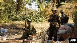 Rebel Kachin Independence Army (KIA) 3rd Brigade soldiers stand guard as they secure an area on Hka Ya mountain in Kachin province on January 20, 2013. Kachin ethnic minority rebels in war-torn northern Myanmar accused the military of launching a fresh at