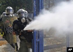 Riot police spray tear gas at demonstrators during clashes in Athens' Syntagma [Constitution] square, October 19, 2011.
