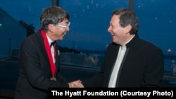 Toyo Ito, left, receives the 2013 Pritzker Architecture Prize from Thomas J. Pritzker, at ceremonies in Boston, May 29, 2013.