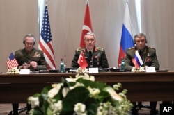 FILE - Turkey's Chief of Staff Gen. Hulusi Akar, center, U.S. Chairman of the Joint Chiefs of Staff Gen. Joseph Dunford, left, and Russia's Chief of Staff Gen. Valery Gerasimov attend a meeting in the Mediterranean coastal city of Antalya, Turkey, March 7, 2017. Among the items discussed at the unusual meeting was the creation of safe zones in Syria.