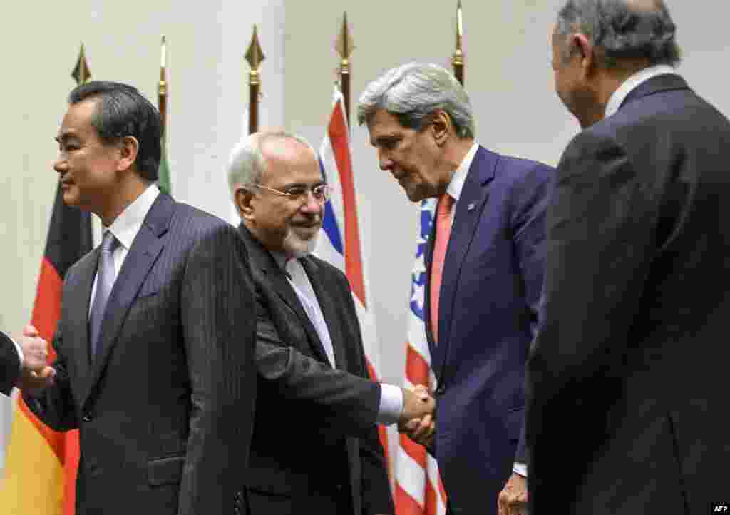 Iranian Foreign Minister Mohammad Javad Zarif (2nd L) shakes hands with U.S. Secretary of State John Kerry next to Chinese Foreign Minister Wang Yi (far L) and French Foreign Minister Laurent Fabius (far R) after world powers agreed to a landmark deal with Iran halting parts of its nuclear program, in Geneva, Switzerland.