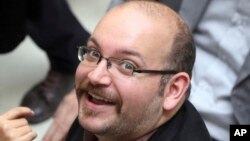 FILE - Jason Rezaian, an Iranian-American correspondent for the Washington Post smiles as he attends a presidential campaign of President Hassan Rouhani in Tehran, Iran.