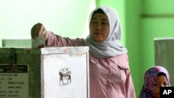 Seorang perempuan memberikan suaranya di di TPS di Jakarta, 19 April 2017.