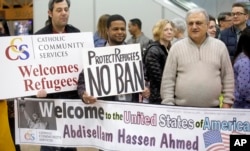 Refugee supporters look on after Abdisellam Hassen Ahmed, a Somali refugee who had been stuck in limbo after President Donald Trump temporarily banned refugee entries, arrives at Salt Lake International Airport in Salt Lake City, Utah., Feb. 10, 2017.