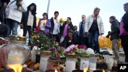 People light candles outside Kronan school in Trollhattan, Sweden following a knife attack on Thursday, October 23, 2015.