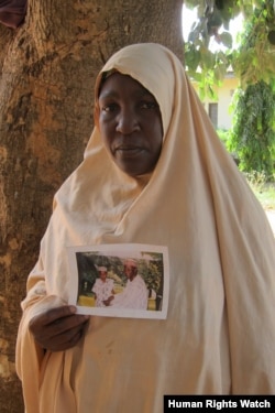 A Muslim woman, from the Hausa-Fulani ethnic group, holds up a photograph of her husband who was killed on April 19, 2011 in Zonkwa, Kaduna State. (Photo: © 2011 Eric Guttschuss/Human Rights Watch)