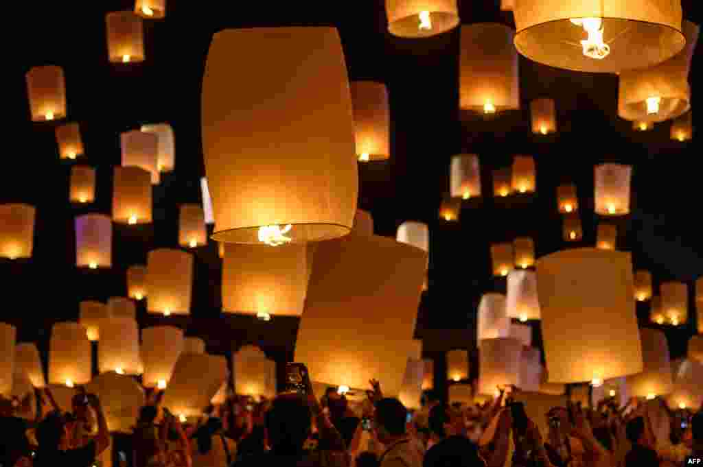 People light and release paper lanterns during the celebration of Loy Krathong festival outside Chiang Mai, Thailand, Oct. 31, 2020.