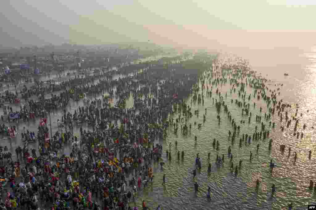 Hindu devotees gather to take a holy dip in the Bay of Bengal during the Gangasagar Mela, at Sagar Island, some 150 kilometers south of Kolkata, India.