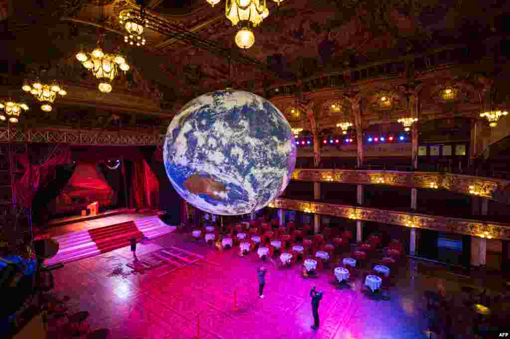 Members of the public admire an illuminated art installation entitled &#39;Gaia&#39; by artist Luke Jerram in the Blackpool Tower Ballroom, as part of the Lightpool Festival of visual arts in the center of Blackpool, northern England, Oct. 14, 2019.