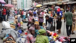 FILE - Pedestrians shop at a busy Balogun Market in Lagos, Nigeria, Sept. 5, 2017. Nigeria announced it will start issuing visas on arrival to all Africans as a way to improve intra-African trade.