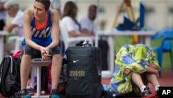 FILE - Russia's Maria Kuchina, left, prepares to compete in the Russian Athletics Cup, at Zhukovsky, outside Moscow, Russia, July 21, 2016. Kuchina is among 10 Russians the IAAF has so far approved this year to compete as neutrals.