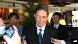 FILE - Zhang Zhijun, director of the Taiwan Affairs Office (TAO), is asked for comments by journalists after meeting with Taiwan's former Vice President Vincent Siew in Bali, Indonesia, Sunday, Oct. 6, 2013. 