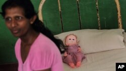 In this 2013 file photo, a resident of Half Way Home, a home for the mentally ill, sits on her bed in Mulleriyawa, on the outskirts of Colombo, Sri Lanka, 