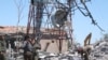 Fighters from the Kurdish People's Protection Units (YPG) inspect the damage at their headquarters after it was hit by Turkish airstrikes in Mount Karachok near Malikiya, Syria, April 25, 2017.
