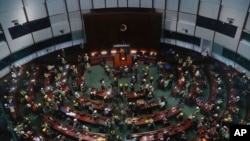 FILE - In this July 1, 2019, photo, protesters gather inside the meeting hall after breaking in to the Legislative Council in Hong Kong. From across the political spectrum, Hong Kong residents condemned mob violence at the U.S. Capitol, 18 months after they saw protesters storm their own local legislature.