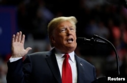 U.S. President Donald Trump acknowledges supporters as he arrives for a campaign rally at the Allen County War Memorial Coliseum in Fort Wayne, Indiana, Nov. 5, 2018.