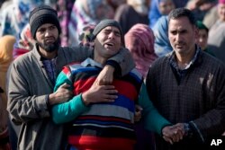 Kashmiri villagers comfort the grieving father of Murtaza, a 14-year-old civilian, during his funeral procession in Pulwama, south of Srinagar, Indian controlled Kashmir, Dec. 15, 2018. At least seven civilians were killed and nearly two dozens injured when government forces fired at anti-India protesters following a gunbattle that left three rebels and a soldier dead.