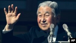Japan's Emperor Akihito waves to well-wishers as he appears on the bullet-proofed balcony of the Imperial Palace in Tokyo, Dec. 23, 2017. Akihito marked his 84th birthday on Saturday with a pledge to fulfill his duties until the day of his abdication in 2019, and to prepare for "passing the torch to the next era." 