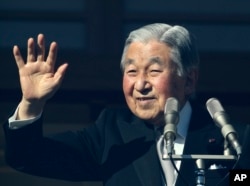 FILE - Japan's Emperor Akihito waves to well-wishers as he appears on the bullet-proofed balcony of the Imperial Palace in Tokyo, Dec. 23, 2017. Akihito marked his 84th birthday on Saturday with a pledge to fulfill his duties until the day of his abdication in 2019.