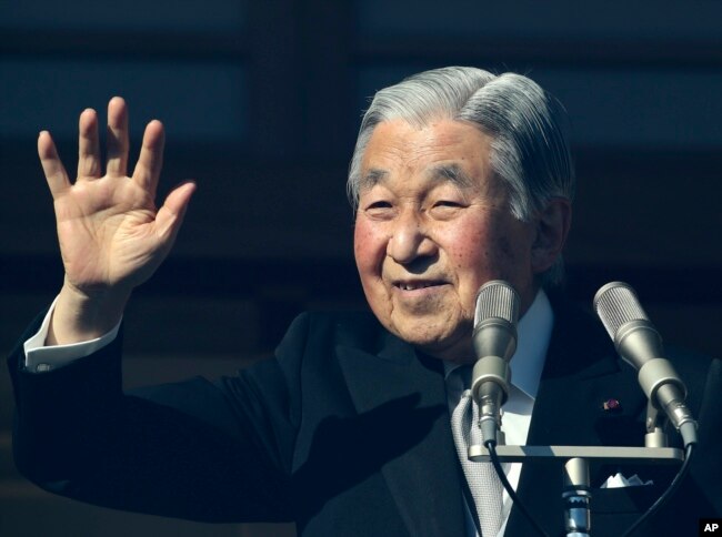 FILE - Japan's Emperor Akihito waves to well-wishers as he appears on the bullet-proofed balcony of the Imperial Palace in Tokyo, Dec. 23, 2017. Akihito marked his 84th birthday on Saturday with a pledge to fulfill his duties until the day of his abdication in 2019.