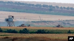 Turkish army tanks hold positions near the border with Syria, in the outskirts of the village of Elbeyi, east of the town of Kilis, in southeaster Turkey, July 23, 2015. 