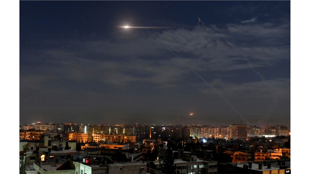 In this photo released by the Syrian official news agency SANA, shows missiles flying into the sky near international airport, in Damascus, Syria, Jan. 21, 2019