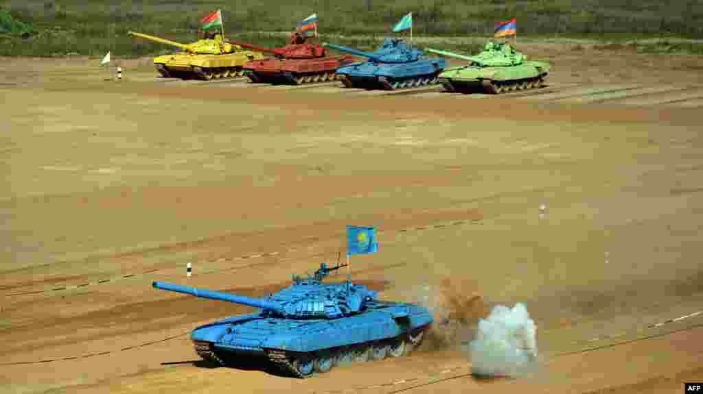 Tanks of (back L-R) Belarus, Russian, Kazakh and Armenian teams line up as they compete during &lsquo;tank biathlon&rsquo;, a new paramilitary sport about armor races and precision gunnery near Alabino, outside Moscow, Russia.