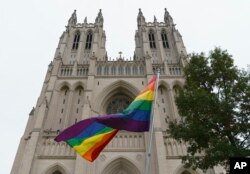 A gay pride flag flies outside the Washington National Cathedral in Washington, Oct. 26, 2018, following a "Thanksgiving and Remembrance of Matthew Shepard" service.