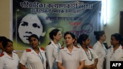 FILE - Indian nurses gather to pay their respects for nurse Aruna Shanbaug at a hospital in Mumbai, India, May 18, 2015. Shanbaug died on May 18 after 42 years in a coma following a brutal rape, in a case that led India to ease some restrictions on euthan