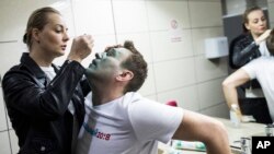 지난달 27일 러시아 모스크바에서 알렉세이 나발니 야당 대표가 괴한으로부터 녹색 화학 염료 공격을 받은 후 그의 아내가 응급처치를 하고 있다.