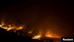 FILE - A forest fire burns out of control in Las Manchas, on the southwestern part of La Palma island, Spain, early August 5, 2016.